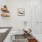 Bathroom with stand up shower, white tile, sink, and large vanity mirror